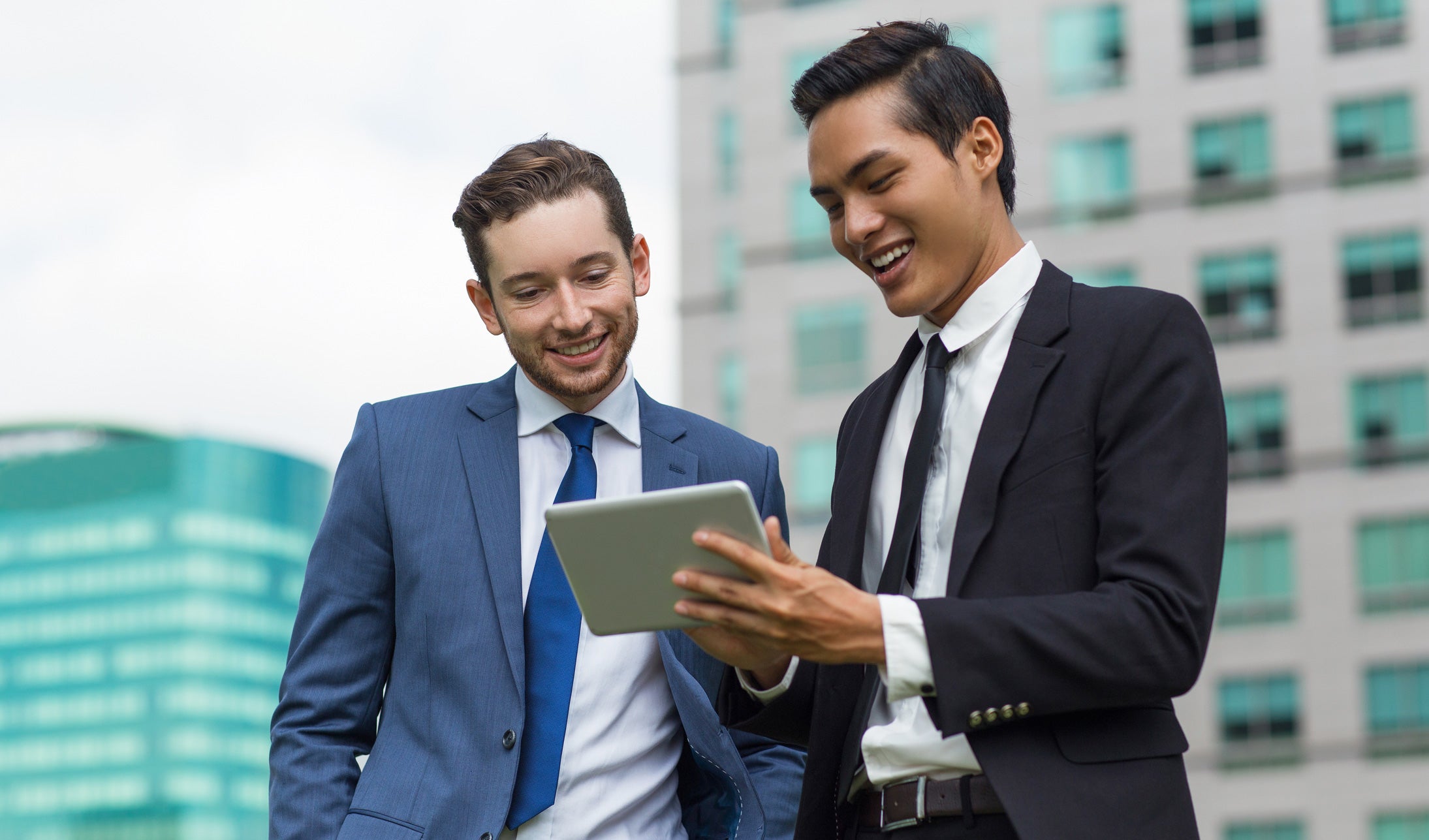 Two businessmen looking at ipad device