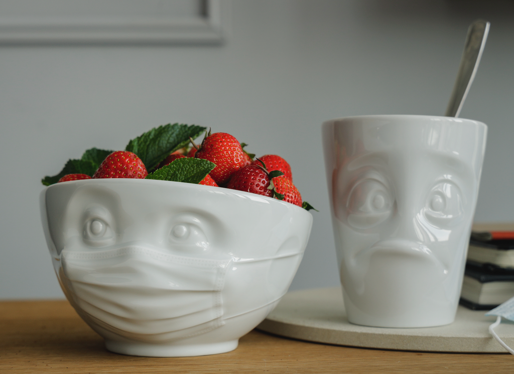 The HOPEFUL porcelain bowl by FIFTYEIGHT Products is a cereal bowl wearing a PPE face mask, with 1 EUR donated to relief efforts from each bowl sold.