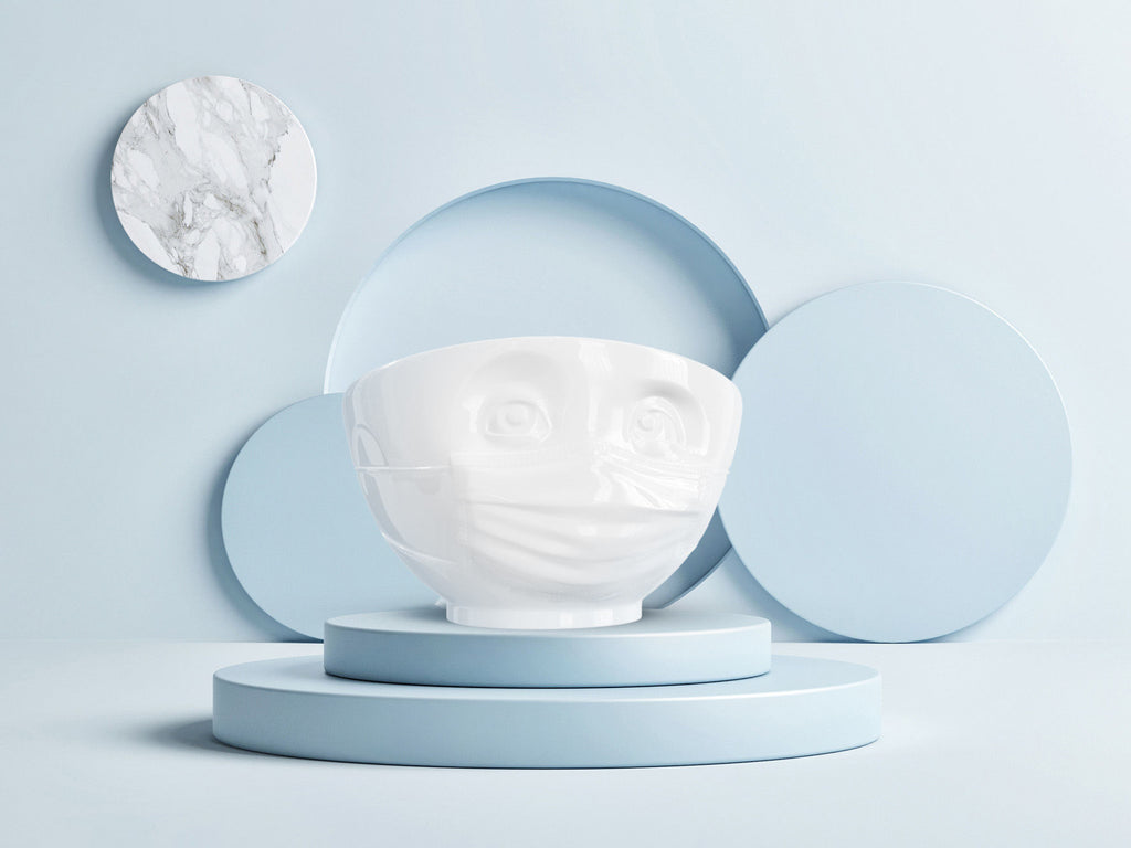 The HOPEFUL porcelain bowl by FIFTYEIGHT Products is a cereal bowl wearing a PPE face mask, with 1 EUR donated to relief efforts from each bowl sold.