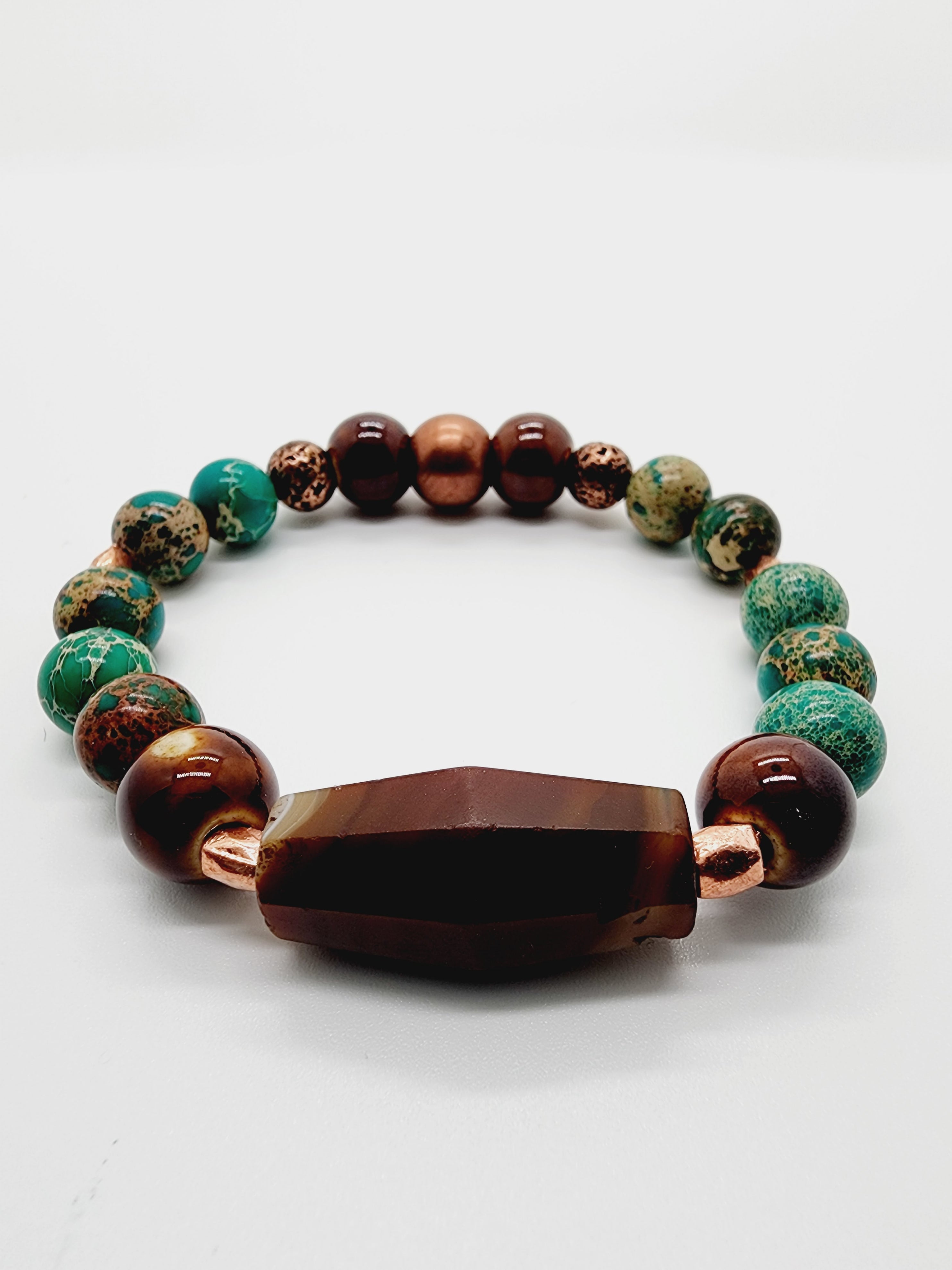 Length: 7.75 inches | Weight: 1.1 ounces  Distinctly You! This bracelet is handmade using brown, green and copper beads, and bracelet uses 8mm latex free clear stretch cord. 