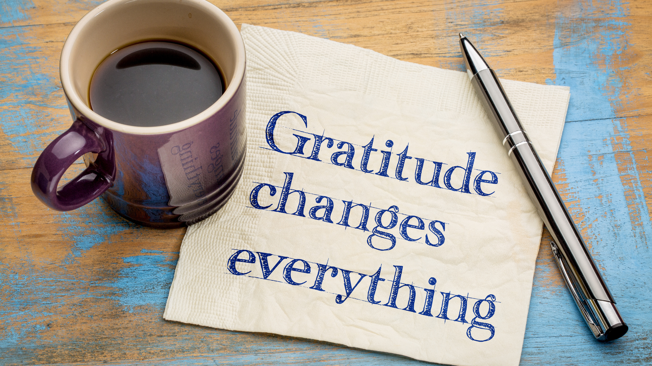 Gratitude changes everything, cup of coffee and a pen