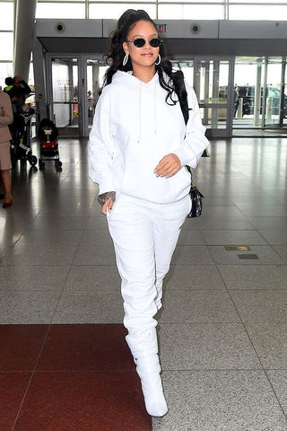 Singer Rihanna walking through airport in tracksuit