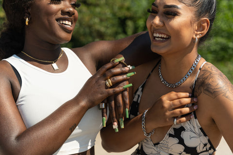 two models wearing E's Element water resistant jewelry on the beach