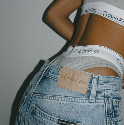 Close up of model's back, showcasing the upper hem of jeans 