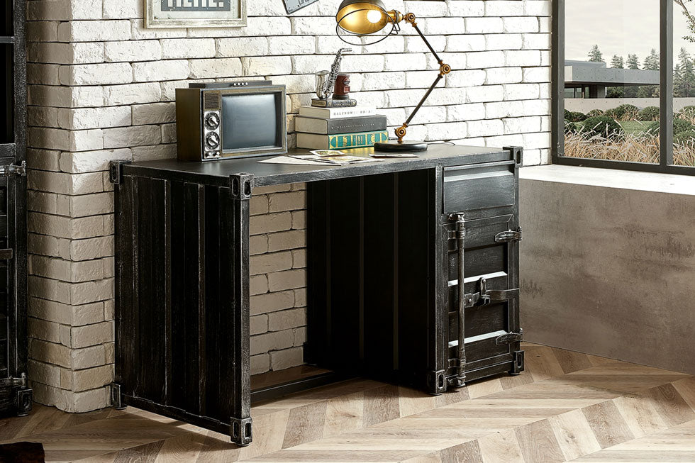  Industrial metal desk with metal desk lamp set against white washed brick wall