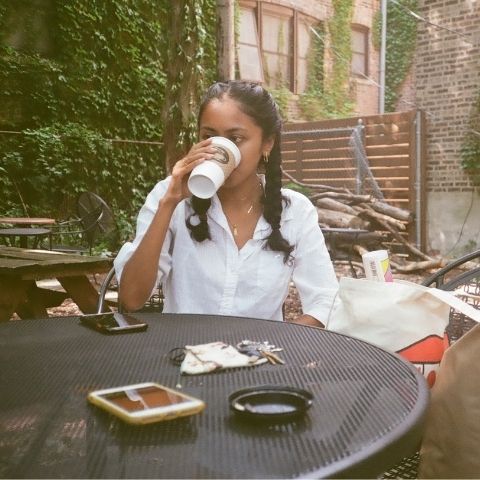 Uma Patel sipping coffee