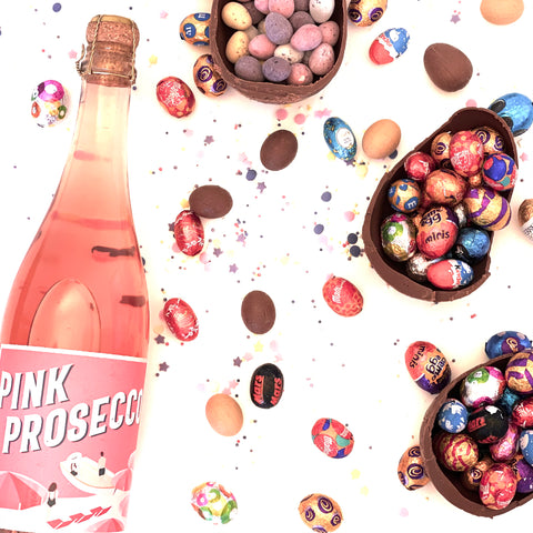 Pink Prosecco bottle with colourful chocolate Easter eggs