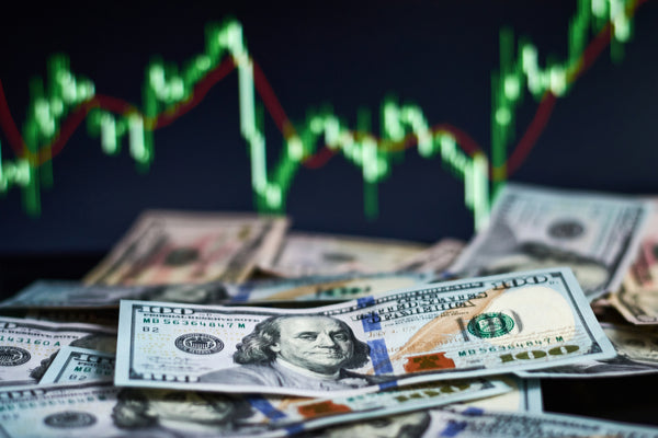 US dollar bills on background with dynamics of exchange rates. Trading and financial risk concept