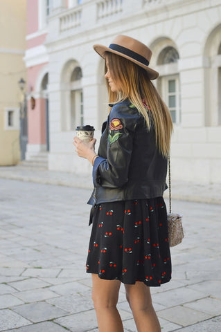 Femme de dos avec une veste noir en simili cuir