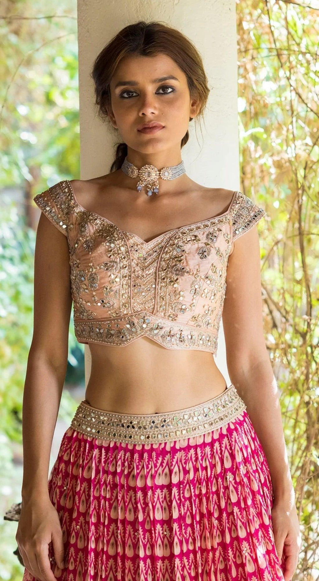 Photo of Bride wearing a bright pink lehenga with a white dupatta.