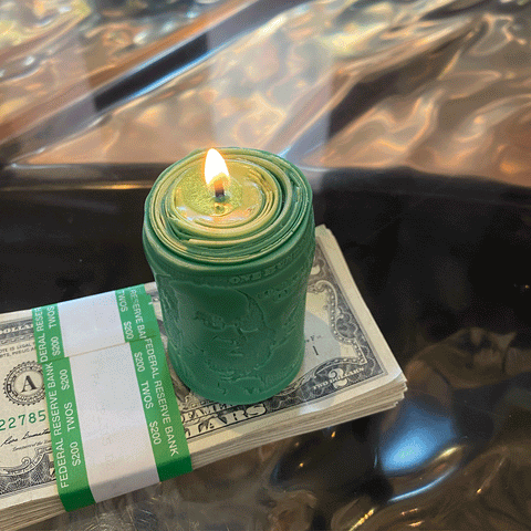 2 dollar bill with a luck money candle