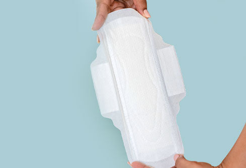 Girl holding cotton sanitary pad 