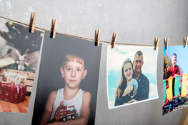 photos hanging on clothespins