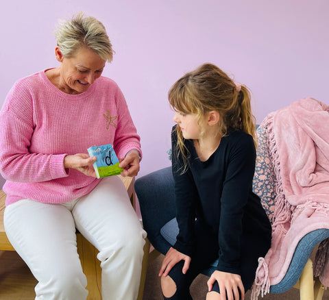 a woman teaching a young child the alphabet using flash cards