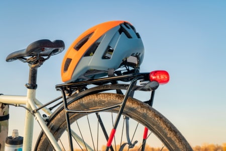 Bicycle helmet on the rear rack of a motorized bike.