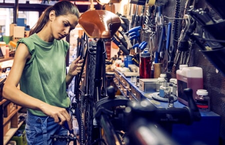 Building and customizing a motorized bicycle in a bike shop.