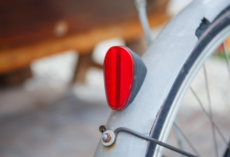 Red rear reflector on motorized bicycle.