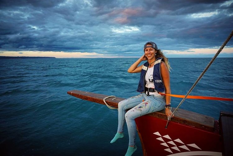 Erika on a bow of a boat