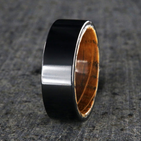 Black titanium wedding band with whiskey barrel sleeve