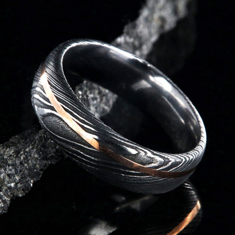 Men's black Damascus steel wedding band with gold inlay