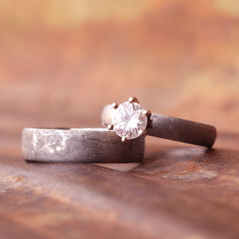 Matching wedding band set made of meteorite and a moissanite stone