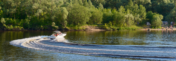 speed boat on lake with passengers enjoying sunny day