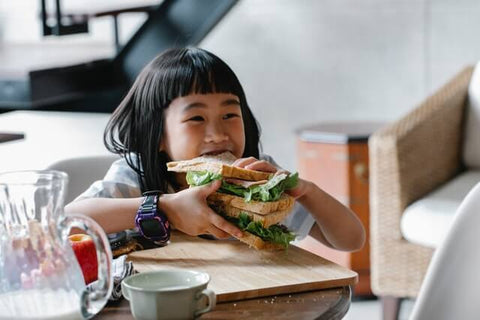 Girl eating heavily a loaf of bread