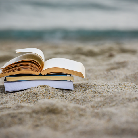 Stack of books on sand