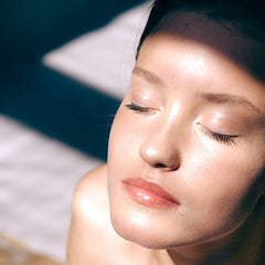 young woman with a clear complexion sunbathing