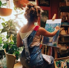 young woman enjoying hobby painting