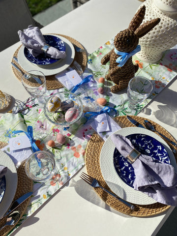 A set table shows vibrant spring colors with Easter decor, including a woven bunny