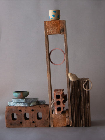 sculpture with ceramic vases, bricks, wood and debris from construction site