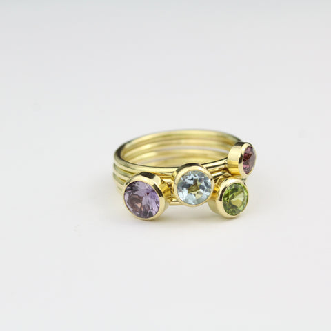 Gold stacking rings with peridot, topaz, amethyst