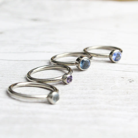 Stacking birthstone rings in blue gemstones