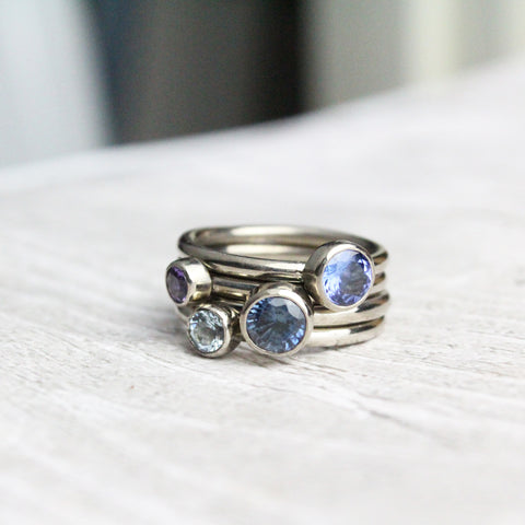 Stacking birthstone rings with sapphire, tanzanite, topaz and amethyst