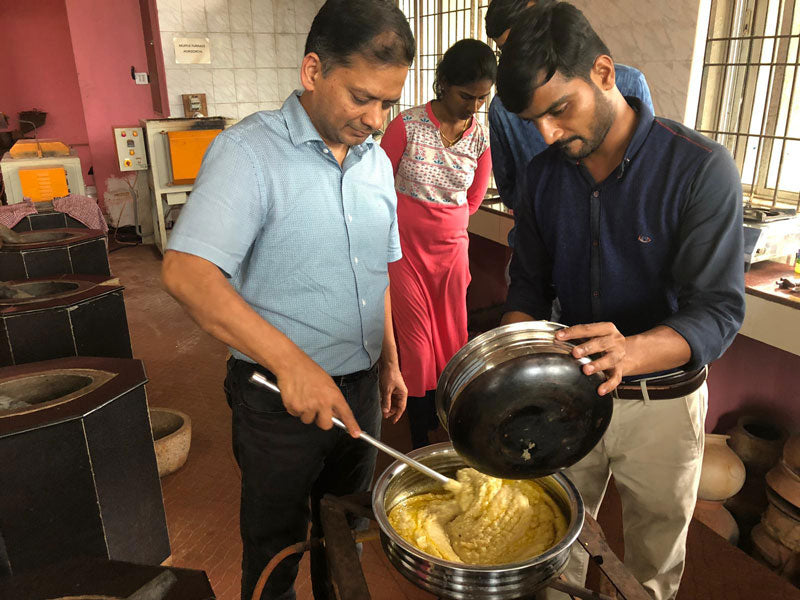 Sandeep working with others to make chyavanprash jam in India.