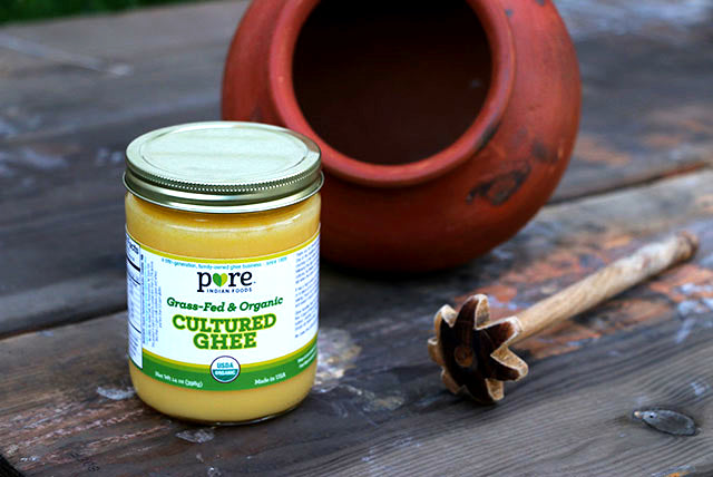 Bilona and clay pot pictured next to jar of Pure Indian Foods Organic Grassfed Cultured Ghee