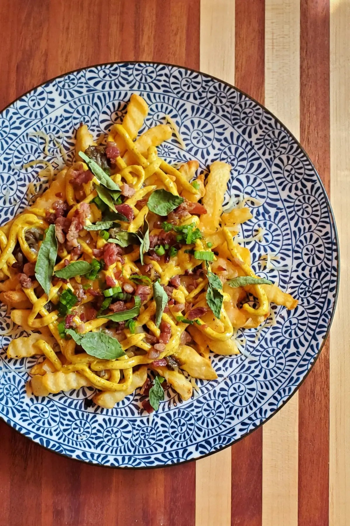Insane Loaded Curry Fries made with Pure Indian Foods Madras Curry Sauce and Organic Curry Powder Seasoning and Curry Leaves