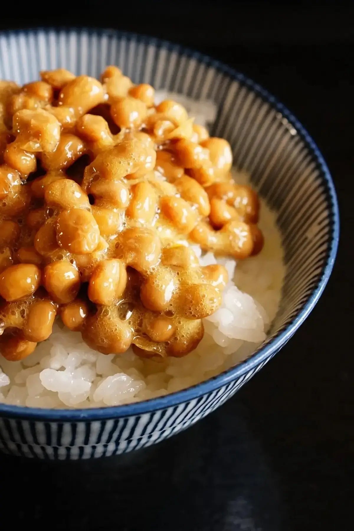 Natto Gohan (Natto with Rice) pictured in a lovely bowl. This Japanese breakfast can be eaten in many easy variations and comes together in less than 5 minutes.