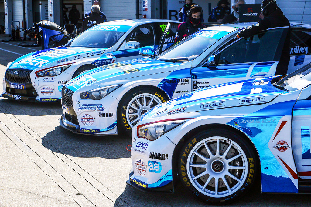 Laser Tools Racing 3 Infinity Q50s outside the garages at Silverstone during BTCC season launch.