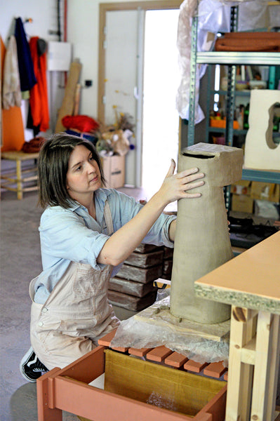 Lea munsch working on a sculpture in clay