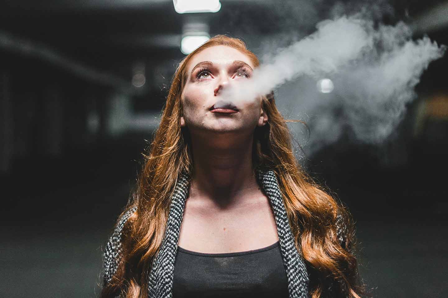 woman blowing smoke