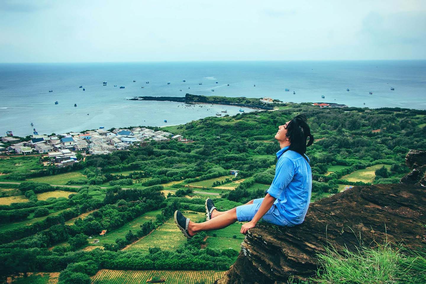 Man sitting on a cliff and enjoying the fresh air