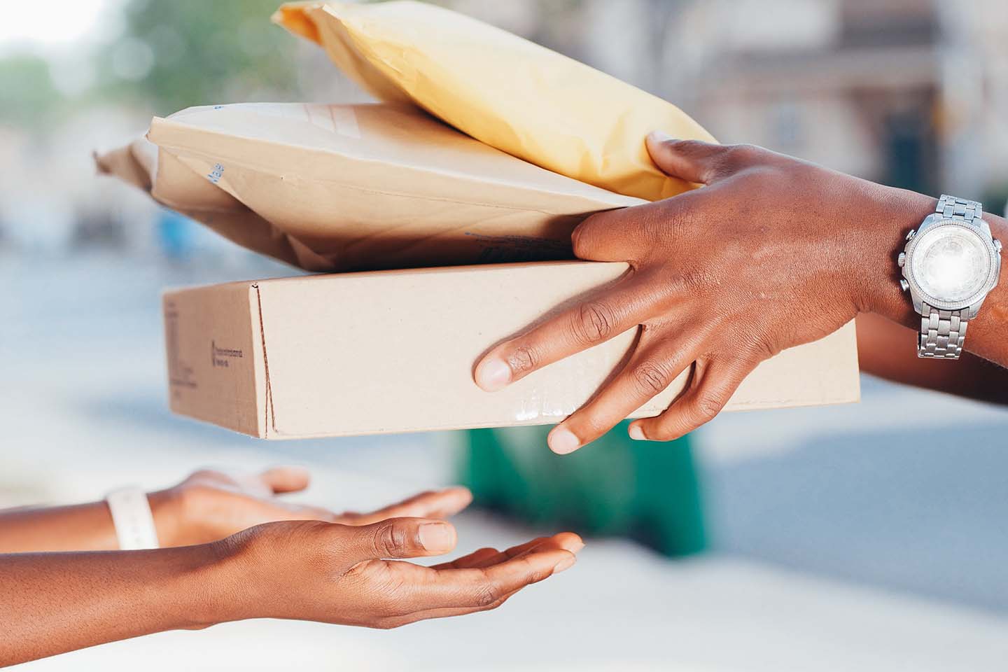 someone receiving a variety of parcels from a delivery person