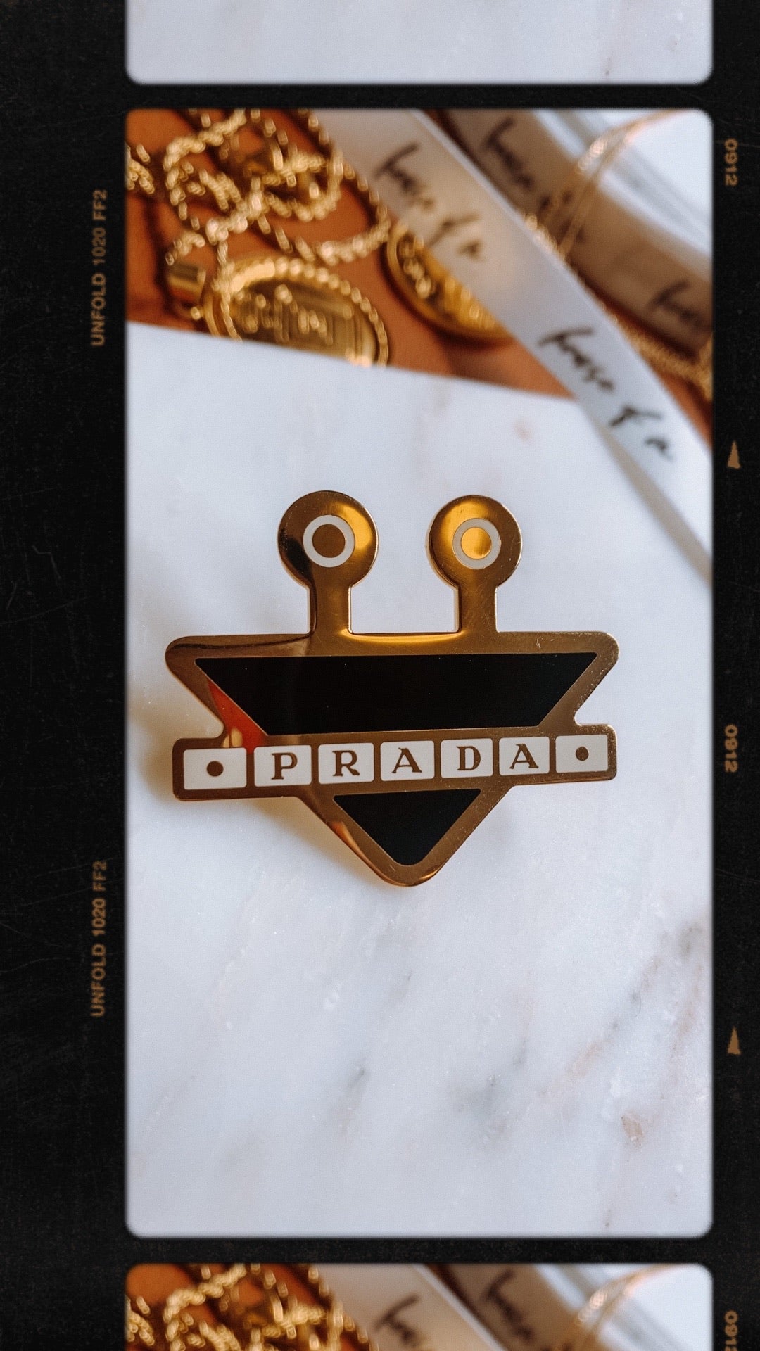 black and gold prada pin – House of Mubina