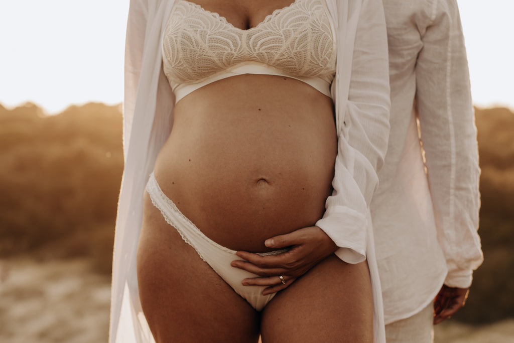 Hotmilk Lingerie Warrio Soft Cup Ivory shown on a full term pregnant mother in a maternity photoshoot