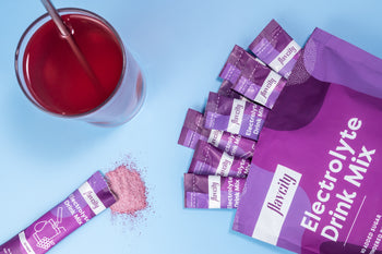Grape Flavor Electrolyte Drink Mix, single serve sticks and prepared drink glass
