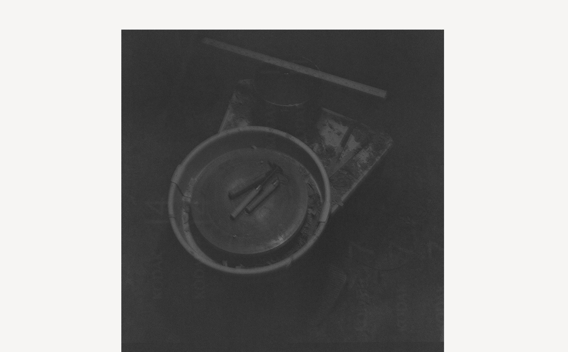 a Pottery wheel in a dark lit black and white photo