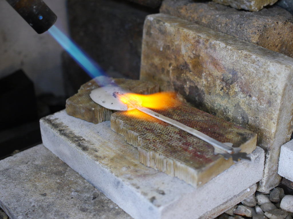 Soldering the handle to the bowl of the spoon