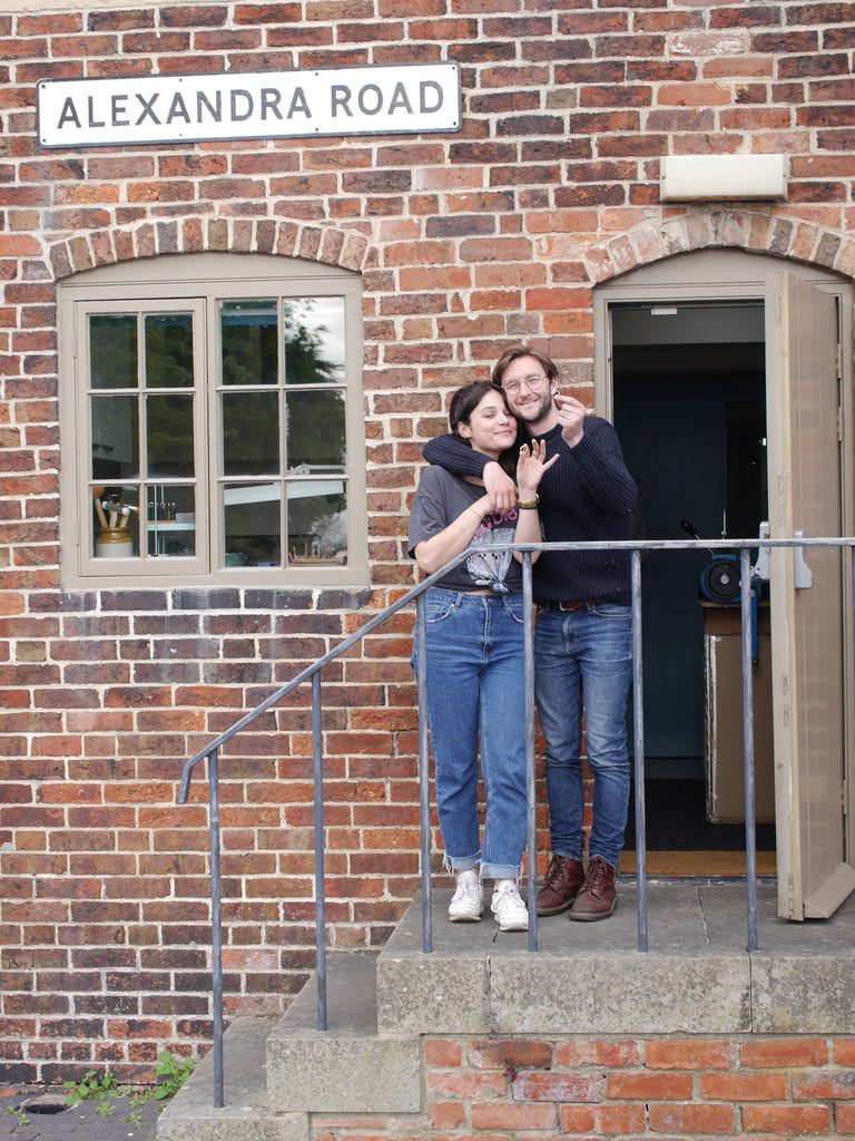 Tom & Fran standing at the doorway of the studio, holding their beautiful finished wedding rings